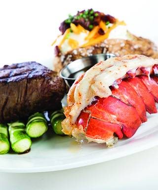 plate of steak and lobster tail on white background