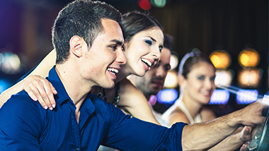 man and woman playing slots