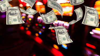 money floating in air over slot machines