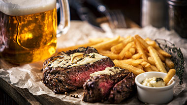 picture of beer with steak and french fries