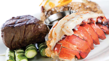 filet and lobster tail with a baked potato and asparagus