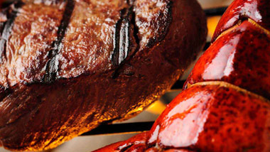 steak and lobster tail on grill
