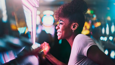 woman excitedly pulling slot lever